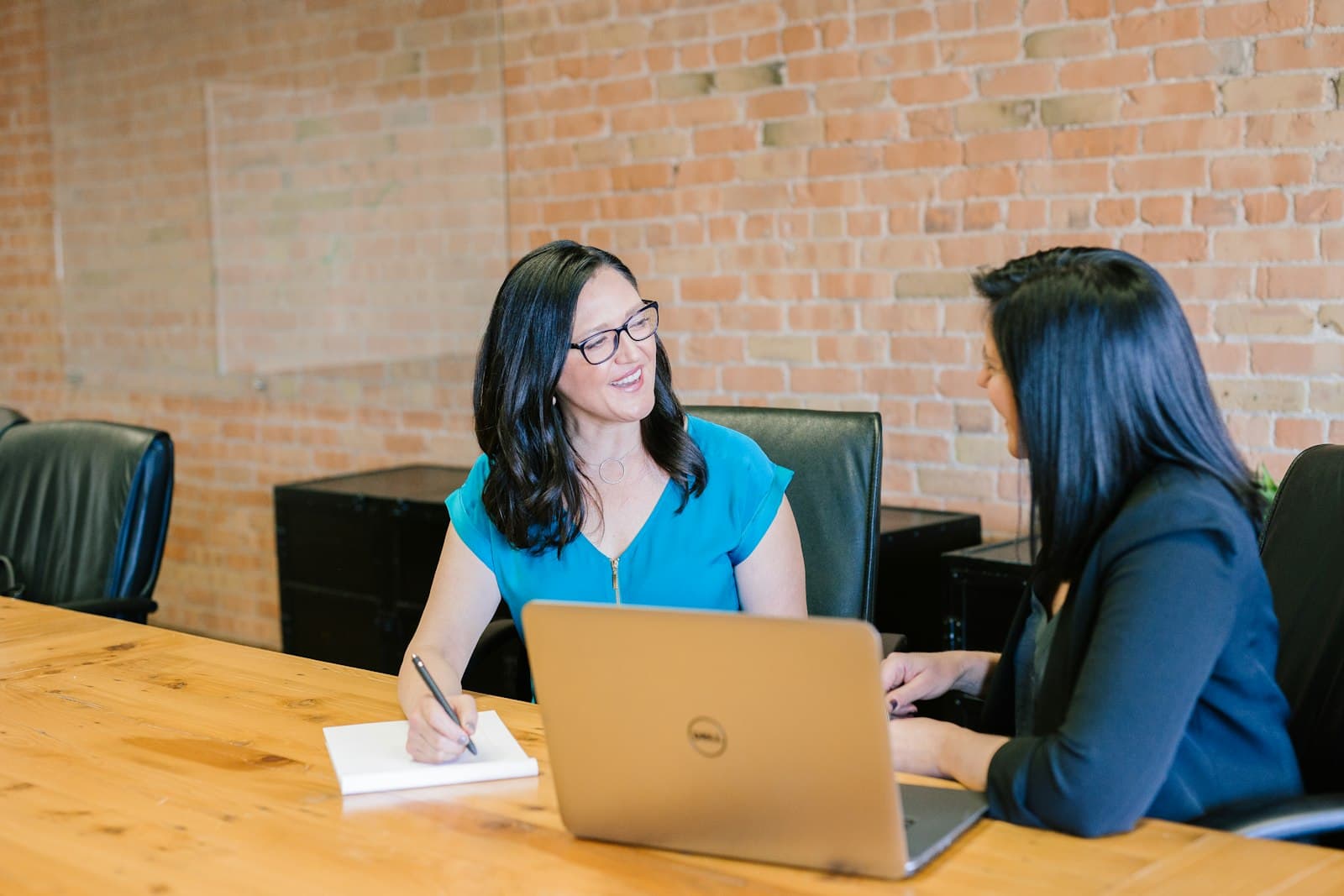 Two people in conversation across a table during a scheduled interview